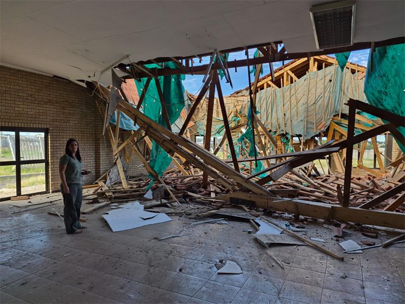 woman look at a broken out window
