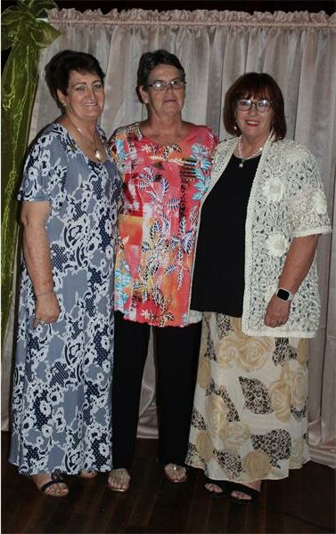three women standing next to each other