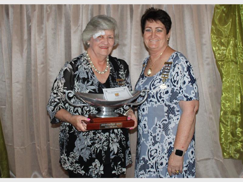 two women with a trophy