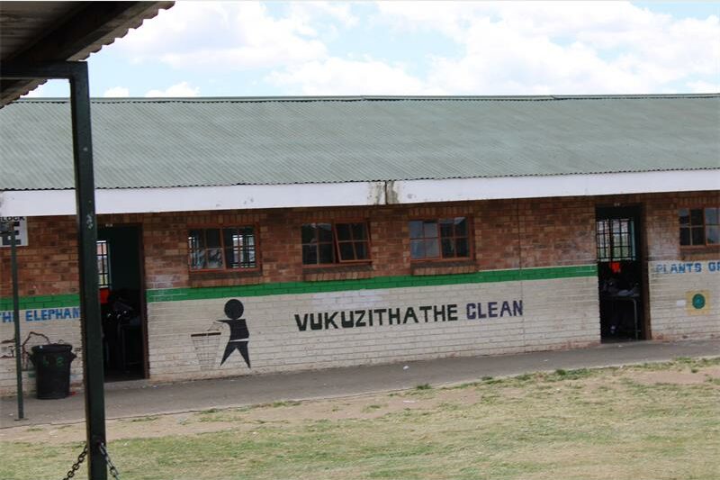 A brick wall on which is painted vukuzithathe clean