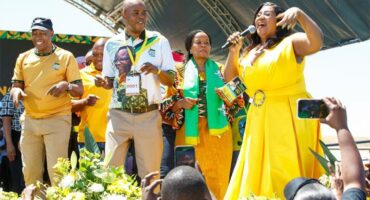 people in ANC regalia on a stage