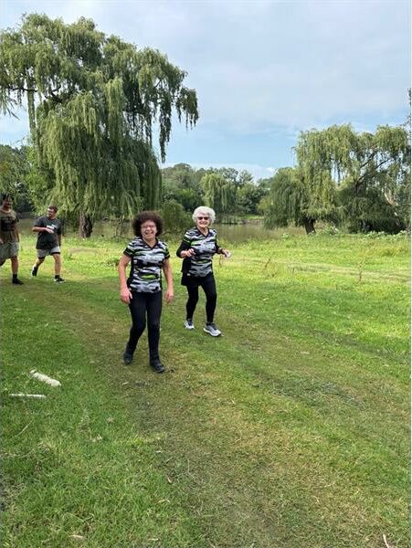 two women wear matching shirts