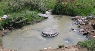 an overflowing sewer manhole
