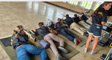 people lie on the stomachs to shoot at targets