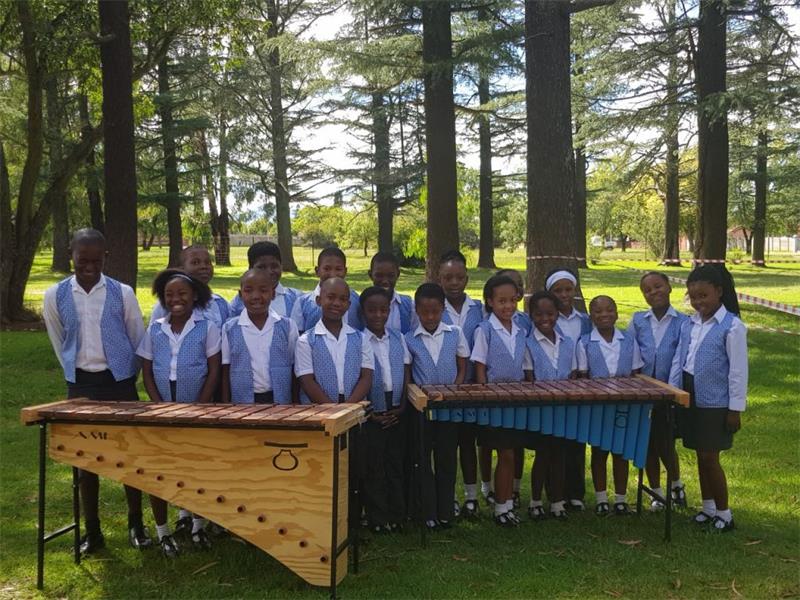 a group of children with the marimba