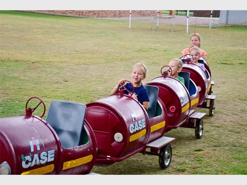 children ride in a play train