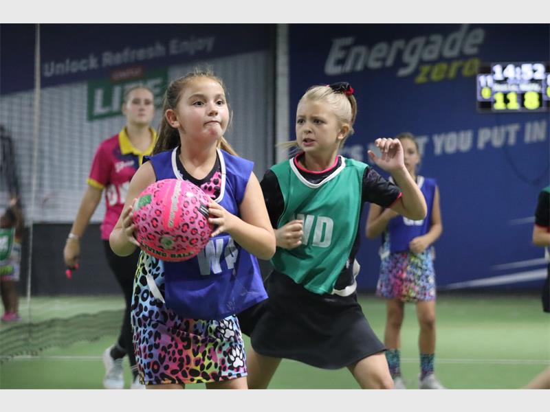 a firl in leopard print and a pink ball