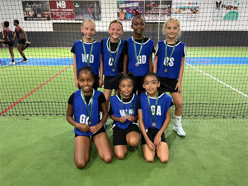 a group of girls in blue bibs