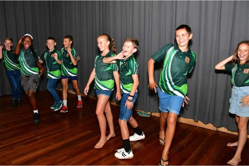 kids in same uniforms are dancing