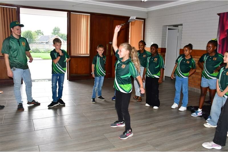 kids in same uniforms are dancing