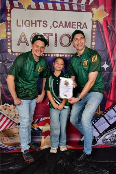 three people with a certificate