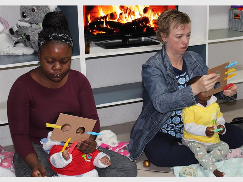 women playing with babies