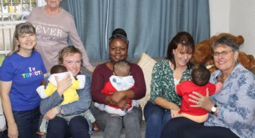 women with babies on their laps