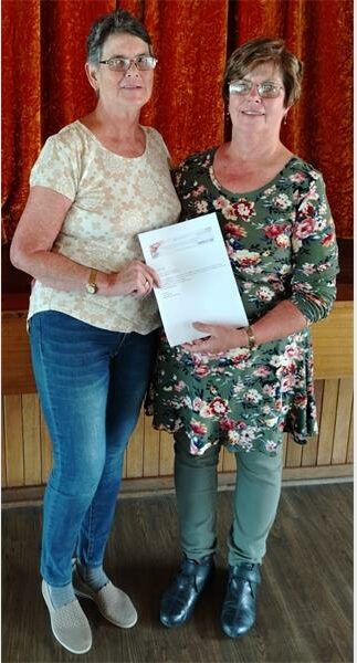 two women holding a certificate