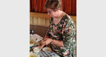 a woman making cottage cheese