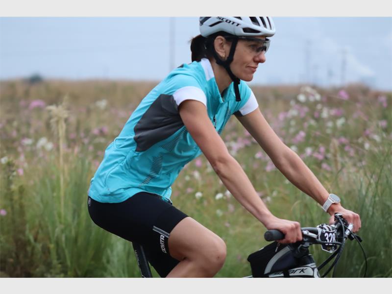 a woman cycles in a mountainbike race
