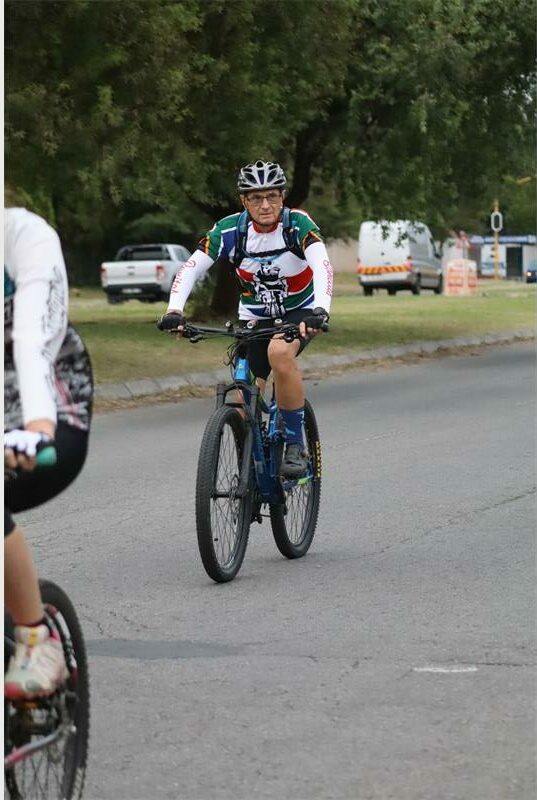 an elderly man on a bicycle