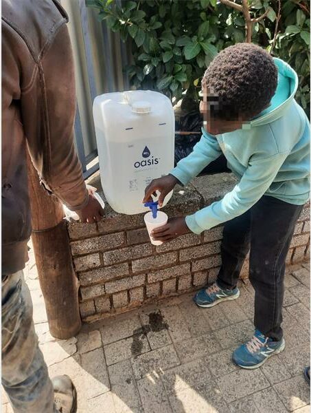 a child fills a glass with water