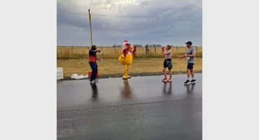 a chicken mascot on the side of the road