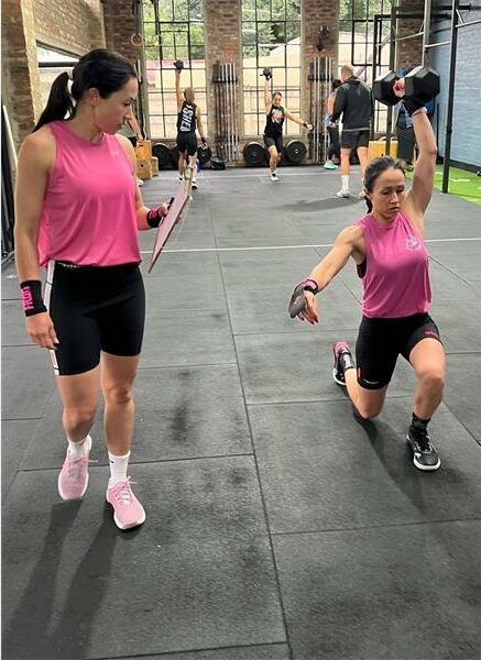 two women in pink shirts do exercises
