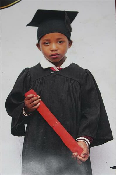 A little girl in graduation garments