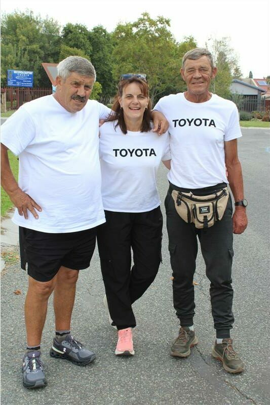 two men and and a woman in white t-shirts and black pants