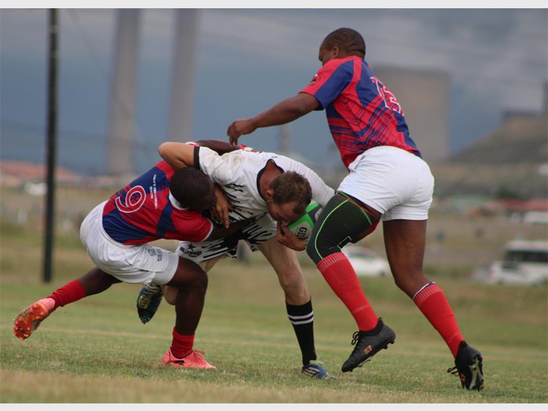 Players Engaged in Intense Rugby Tackle.