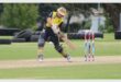 a boy in yellow and black clothes bats in cricket
