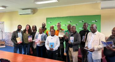 large group holding up books