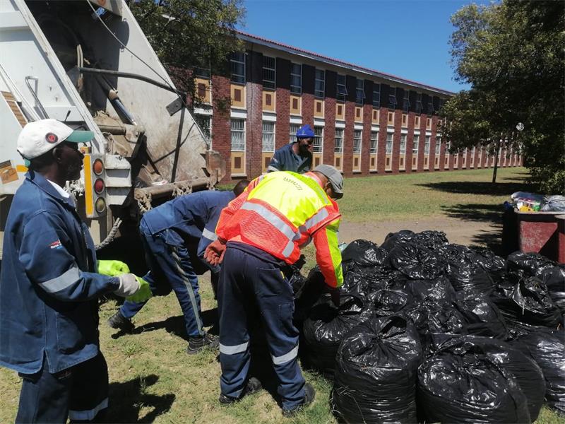 municipal workers removing refuse