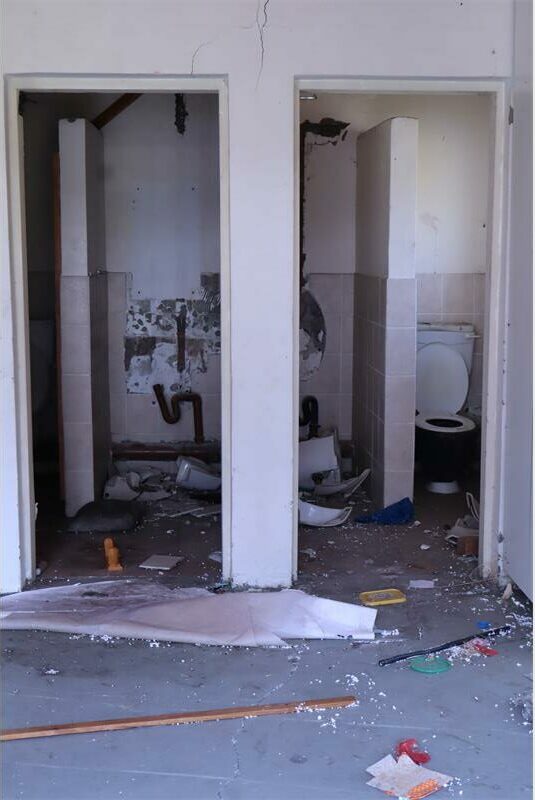 Vandalised bathrooms inside a dilapidated building