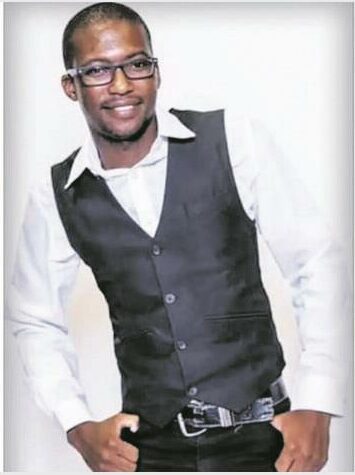 an African man with a white shirt and black undercoat