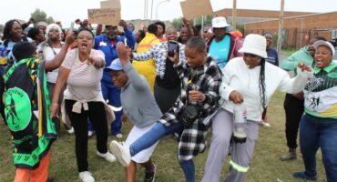 people protest in front of a court house