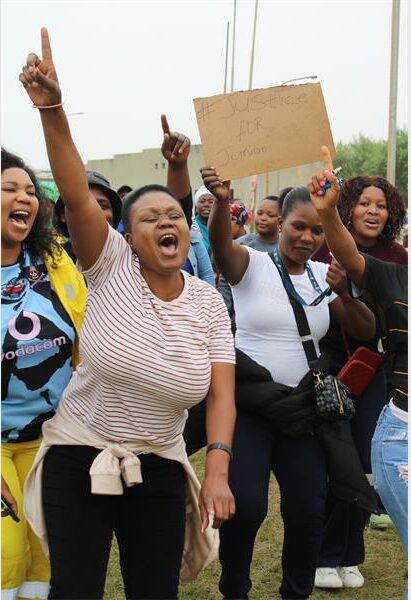 people protest in front of a court house