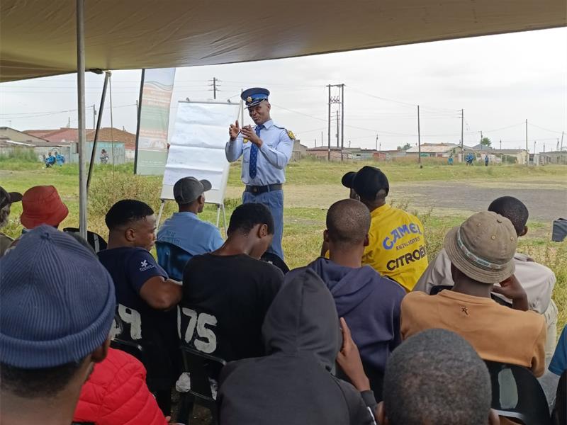 a policeman speaks to men