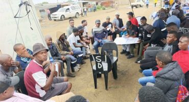 men and boys sitting in a circle