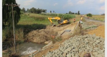 earth work equipment is working on a broke bridge