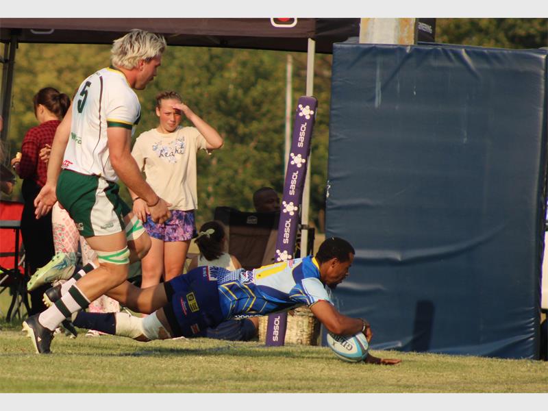 player in blue dives with ball in the hand