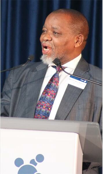 a man with a beard speaks into a microphone