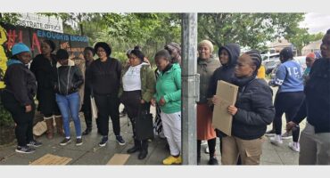 people picket in front of a court building