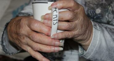 women's hands holding a mug