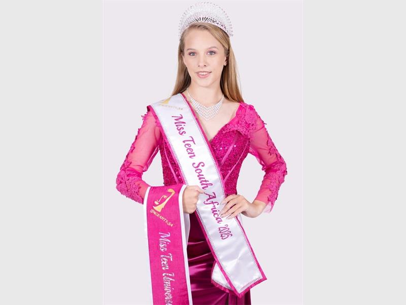 girl in pink with a pageant sash and crown