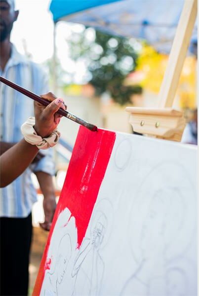 an artist pants a canvas red