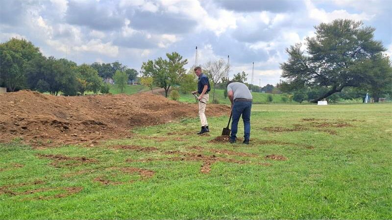 two men prepare a damaged mountainbike route