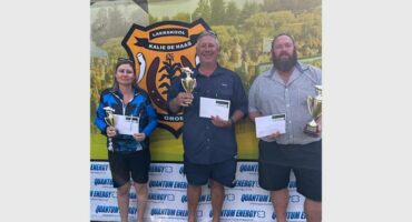 three people with trophies