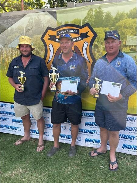 three people with trophies