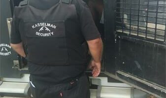 security officer loads someone into their security van