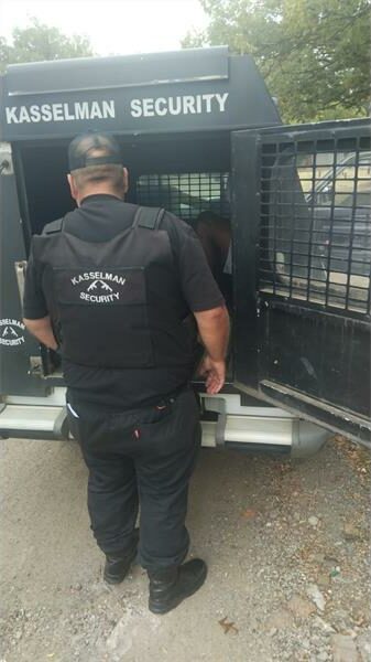 security officer loads someone into their security van