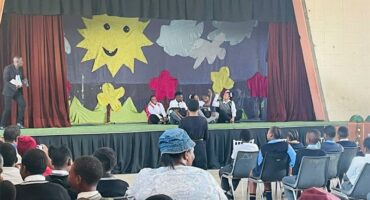 people looking at a school play on stage