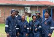 a work crew in blue coveralls